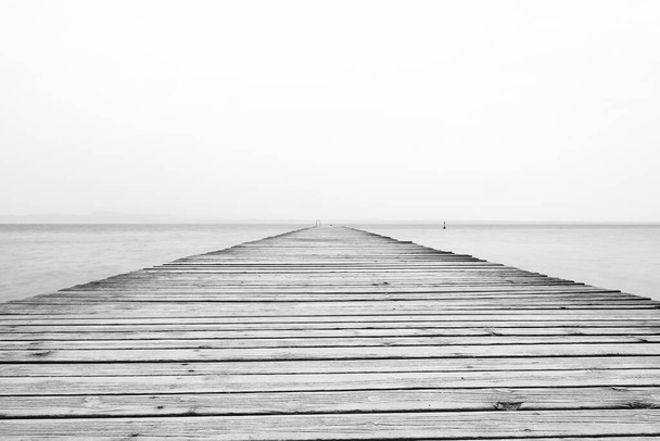 Lake Garda Pier.  The view along a wooden pier from the resort town of Sirmione on the banks of Lake Garda in north east Italy. - Photo, Image