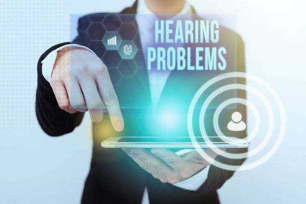 Sign displaying Hearing Problems. Word Written on partial or total inability to hear Hearing impairment Lady In Suit Pointing On Tablet Showing Futuristic Graphic Interface. - Photo, Image