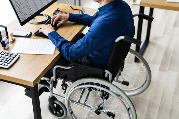 Disabled Handicapped Man In Wheelchair Working Using Computer Technology - Fotoğraf, Görsel