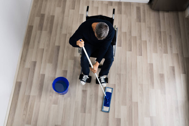 Handicapped Disabled Man Cleaning Kitchen Floor Using Map - Fotó, kép