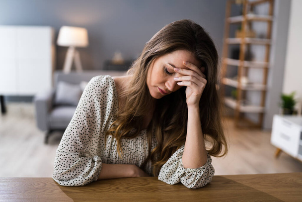 Depressed Sad Young Girl With Headache Sitting At Home - Zdjęcie, obraz