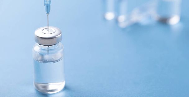 medical concept, close up of a bottle of water on blue background - Fotó, kép