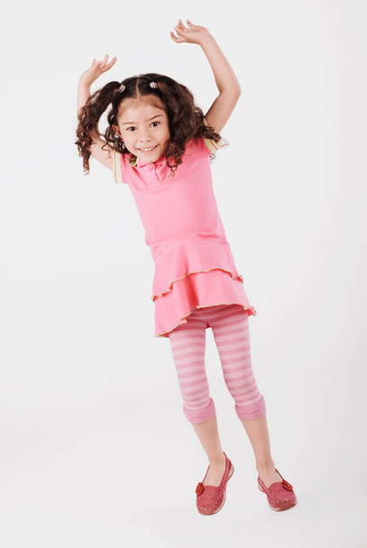 cute little girl jumping on white background - Foto, Imagem