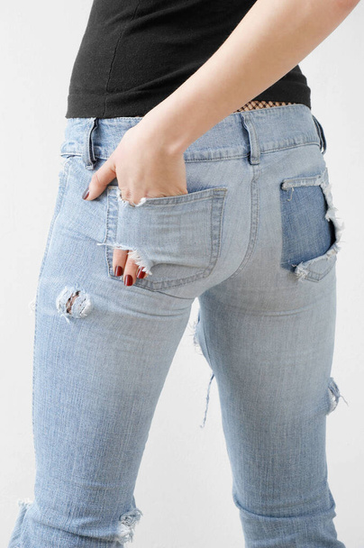 woman in jeans and black pants, closeup - Фото, изображение