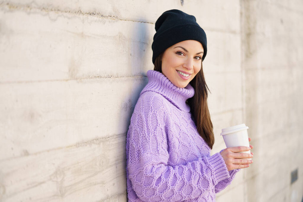 Woman in her twenties taking a coffee break outdoors. - Photo, Image