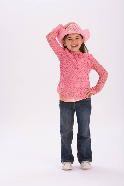 portrait of a cute little girl in a pink dress on a white background - Zdjęcie, obraz