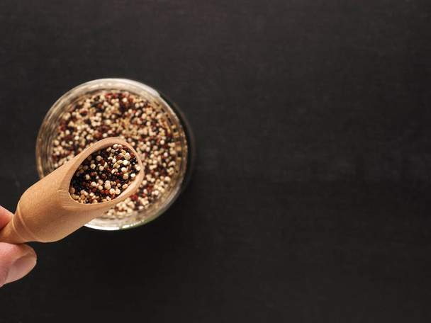Organic quinoa in a jar on a board with space for your text, healthy food concept - Photo, image