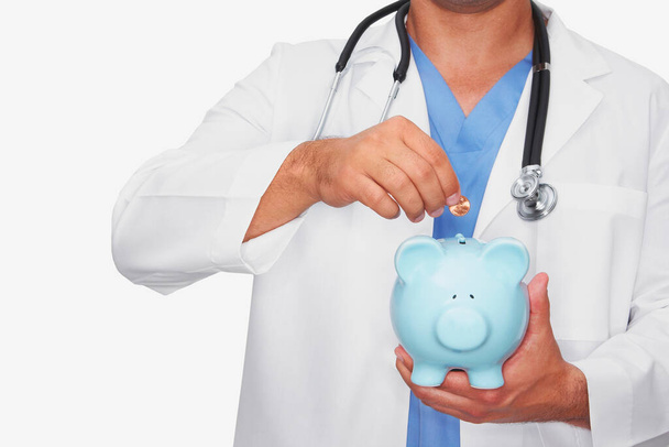 doctor with stethoscope and piggy bank - Фото, зображення