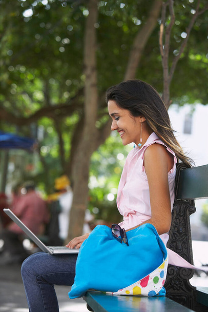 young woman sitting on bench and using laptop - Foto, Imagem