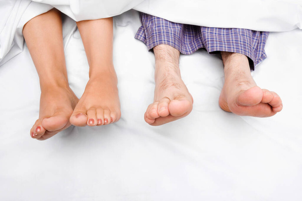 feet of a man lying on the bed - Photo, Image