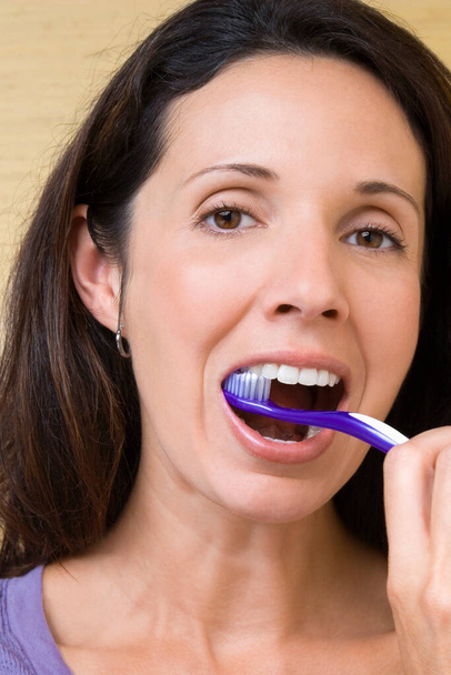close-up of a young woman brushing teeth - Foto, Imagem
