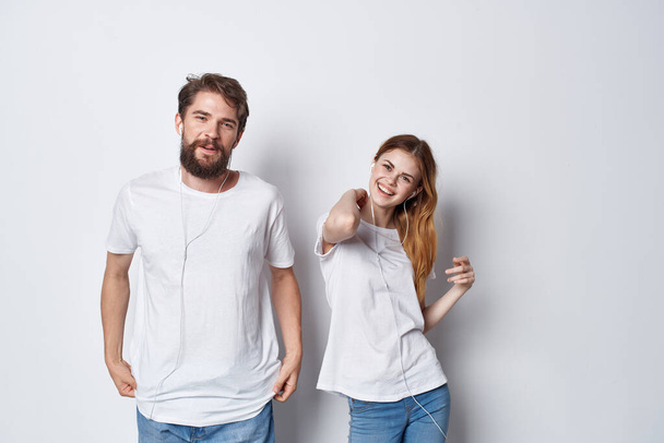 férfi és nő fehér pólóban állnak mellett barátság szórakoztató fény háttér - Fotó, kép