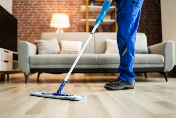 Home Floor Cleaning Service. Man Mopping Living Room - Foto, Imagen