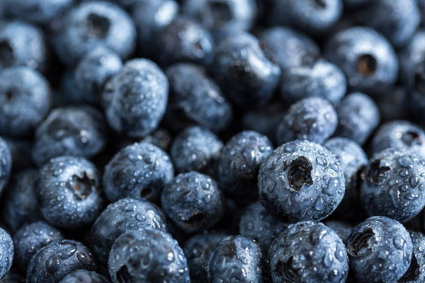 Fresh juicy blueberries background. Flat lay top view copy space. Healthy berry, organic food, antioxidant, vitamin, blue food. - 写真・画像