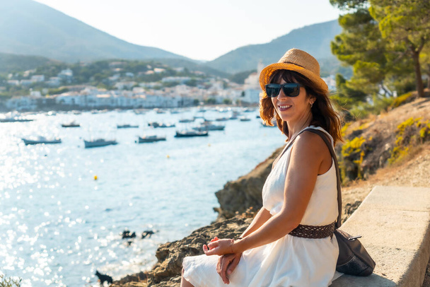 A young woman on summer vacation in Cadaques by the sea, Costa Brava of Catalonia, Gerona, Mediterraneo. Spain - 写真・画像