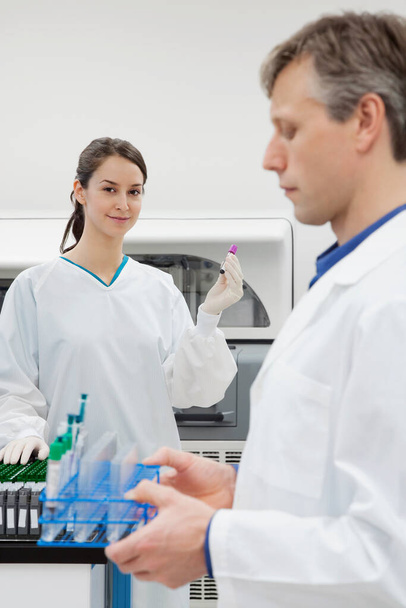 portrait of female doctor and nurse looking at camera while standing in laboratory - Foto, imagen