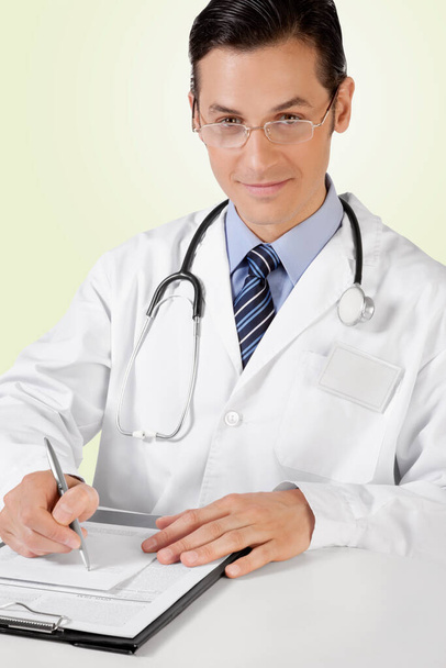 doctor with stethoscope and clipboard - Fotó, kép
