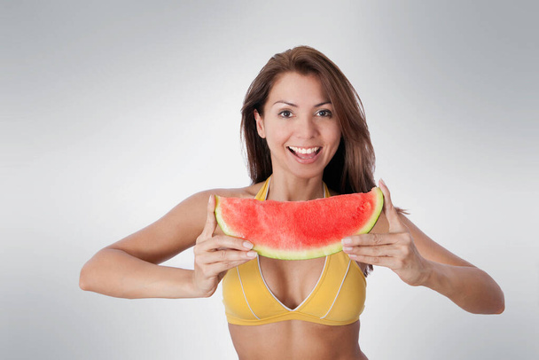 beautiful young woman with a slice of watermelon on a white background - Valokuva, kuva