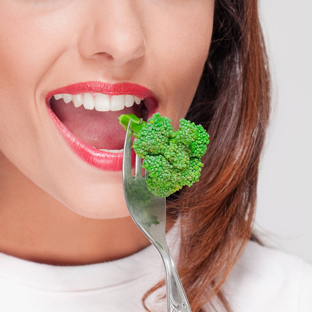 beautiful young woman eating fresh green salad - Fotoğraf, Görsel
