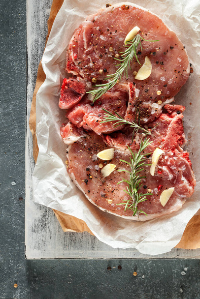 raw beef steak with spices and herbs on a wooden board - Photo, image