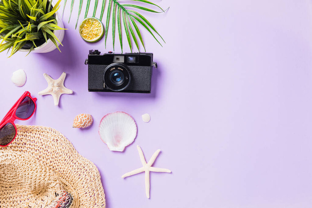 Top view flat lay mockup of camera films, airplane, sunglasses, starfish beach traveler accessories isolated on a purple background with copy space, Business trip, and vacation summer travel concept - Fotoğraf, Görsel