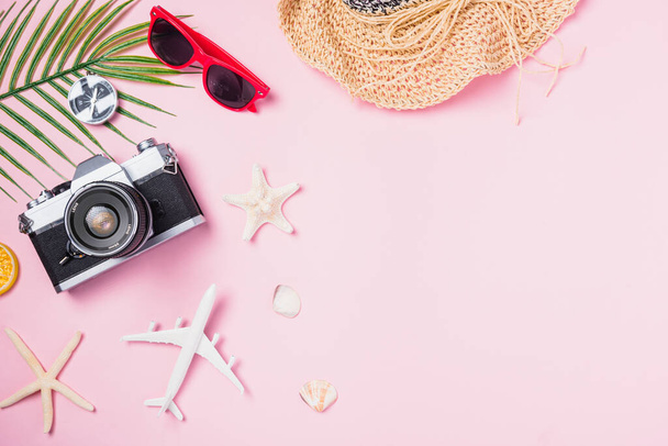 Top view flat lay mockup of retro camera films, airplane, hat, sunglasses, starfish beach traveler accessories on pink background with copy space, Business trip, and vacation summer travel concept - Фото, изображение