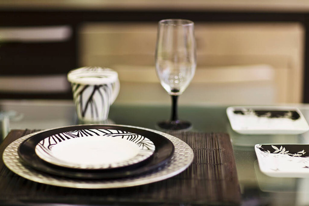 table setting with a white plate and a glass of wine - Foto, Imagen