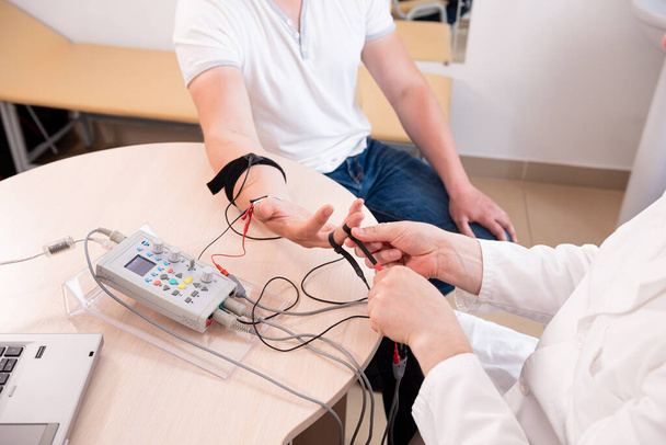 Patient nerves testing using electromyography at medical center - Photo, image