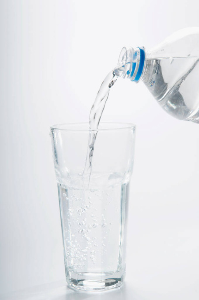 water pouring into glass on white background - Photo, Image