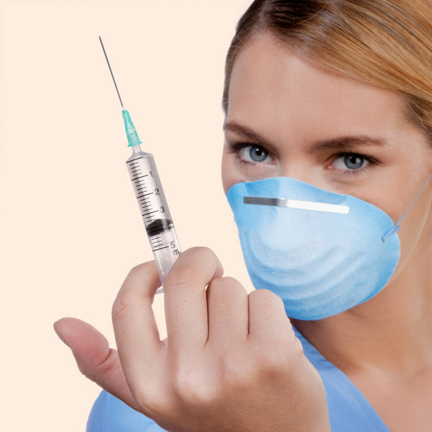 young woman holding syringe with a vaccine - Foto, afbeelding