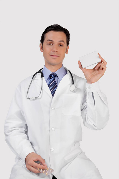 asian doctor holding a clipboard and smiling while standing against white background - Photo, Image
