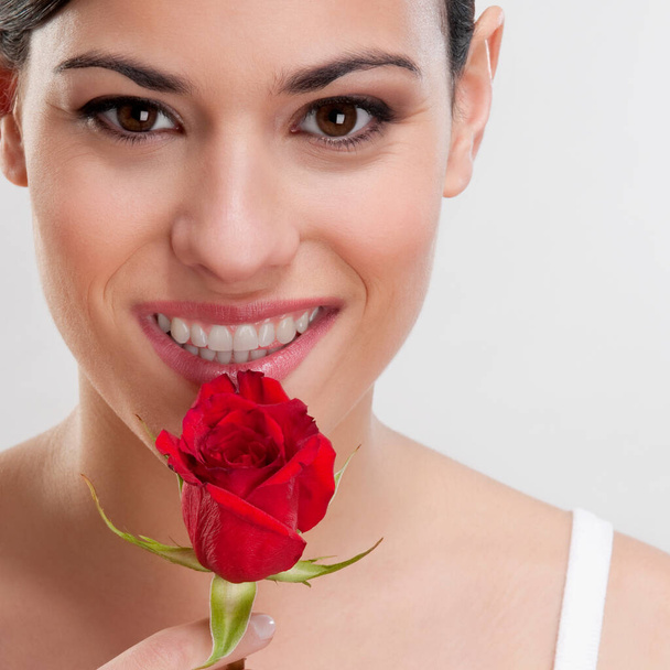 beautiful young woman with red rose on white background - Photo, Image