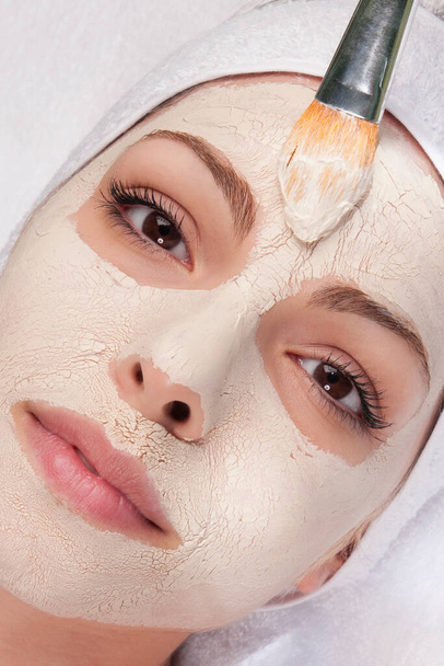 woman applying cosmetic mask on face - Fotografie, Obrázek
