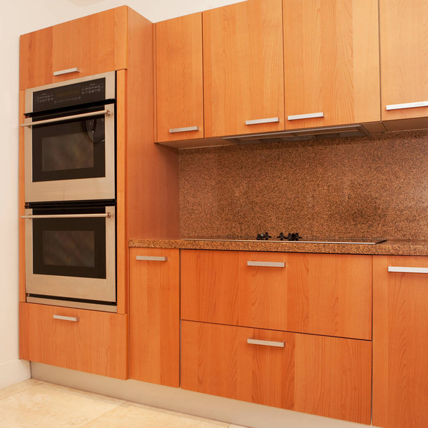 modern kitchen interior with appliances and wooden floor - Foto, afbeelding