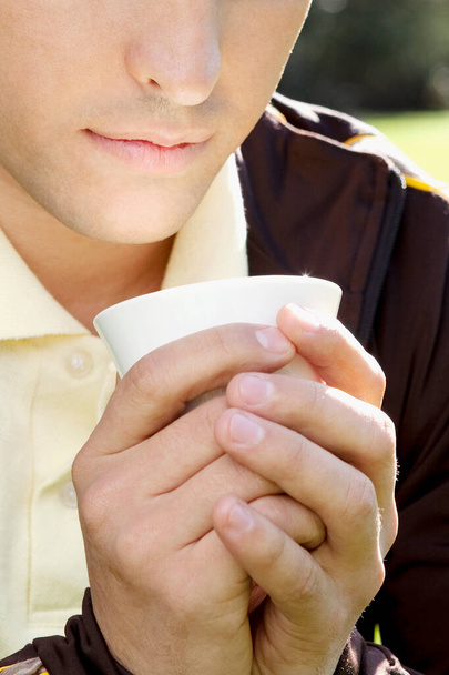 close-up of a woman holding a cup of coffee - Фото, изображение