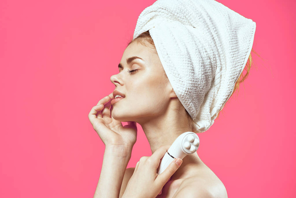 woman with a towel on her head massagers in hands clean skin health care - Foto, immagini