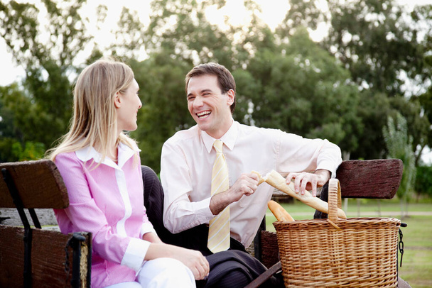 couple in love sitting on bench in park - Photo, image