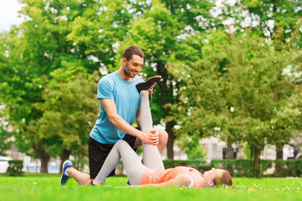 smiling couple stretching outdoors - Photo, image