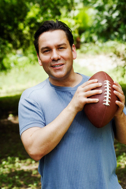 portrait of a young man with a ball on his shoulder - Photo, image