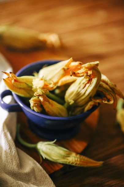 Fresh close up zucchini flowers at the kitchen, delicious - Photo, Image