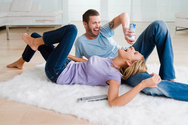 young couple lying on floor and drinking coffee - Foto, Imagem