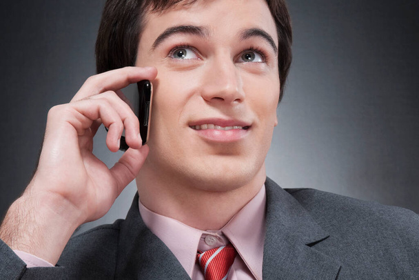 portrait of a young businessman talking on the phone - Fotó, kép
