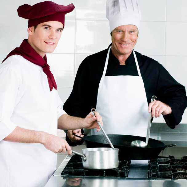 male chef cooks with chefs in kitchen - Fotografie, Obrázek