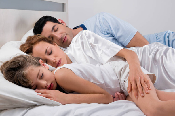 young couple lying on bed in bedroom - Foto, Bild