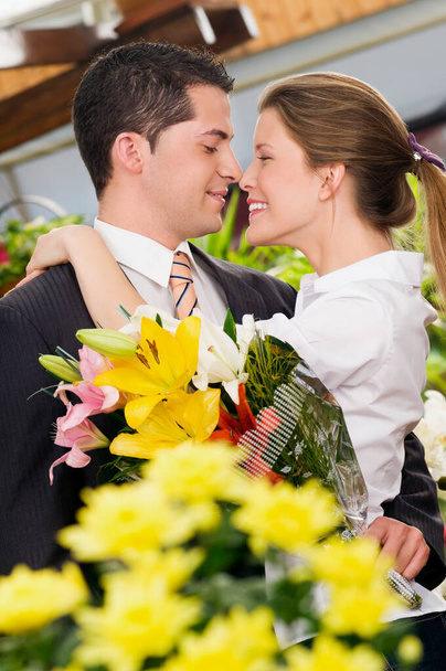 young couple in love with flowers - Foto, imagen