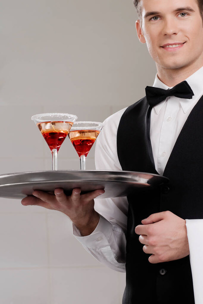 waiter with red wine and a glass of champagne - Foto, imagen