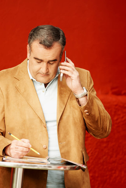portrait of a mature businessman with a mobile phone - Zdjęcie, obraz