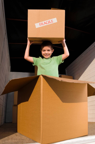 a girl with a cardboard box and a gift boxes - Photo, image