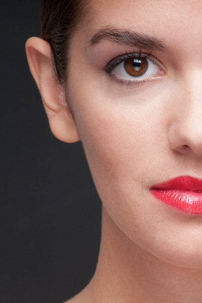 close-up portrait of beautiful woman with red lips on black background - Valokuva, kuva