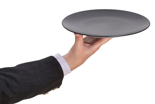 above view of hand with empty flat black plate - Photo, Image